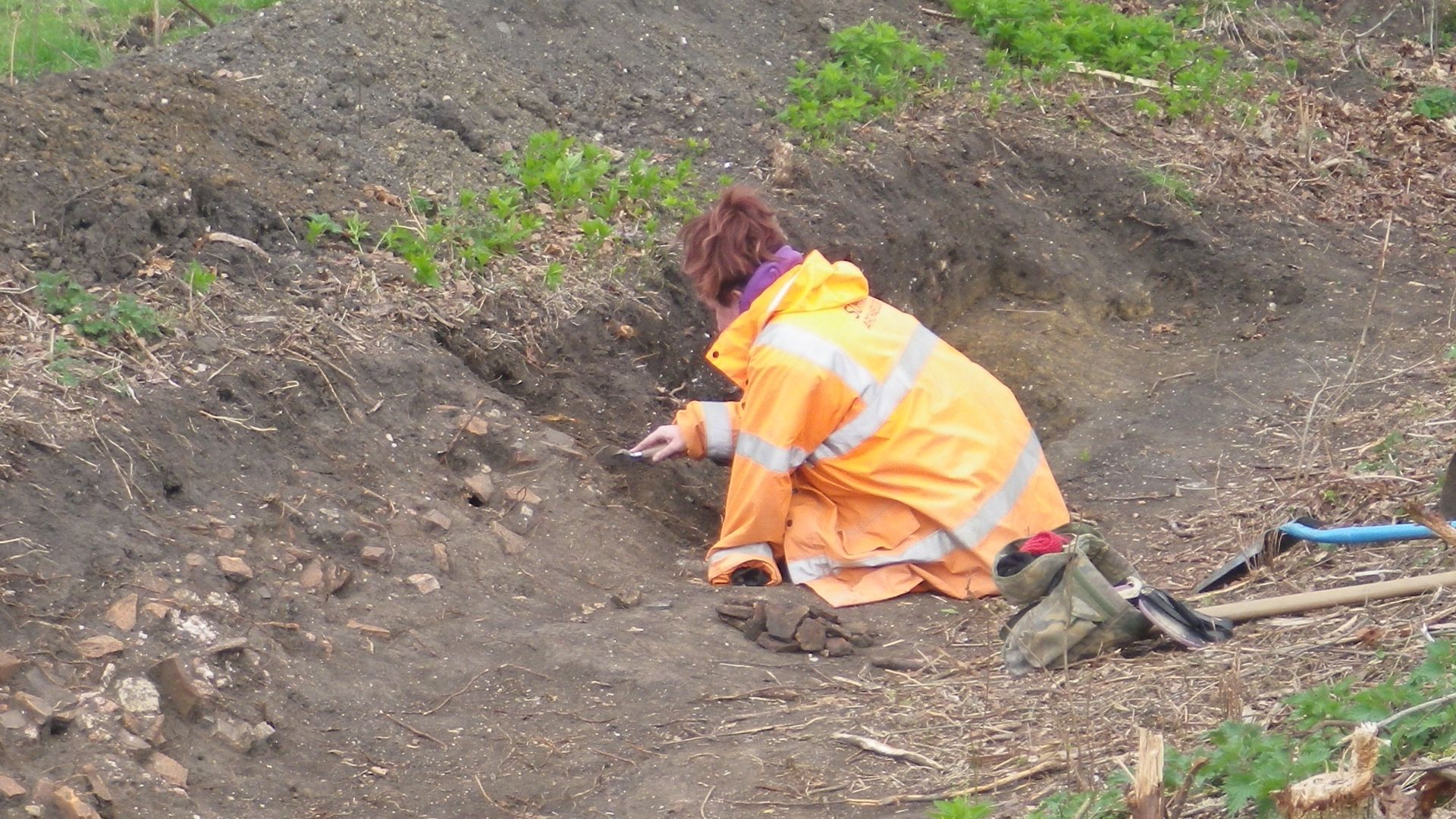 Archaeologist excavating at the Roman Barrow Group and Villa, Rougham, Suffolk, March to December 2017