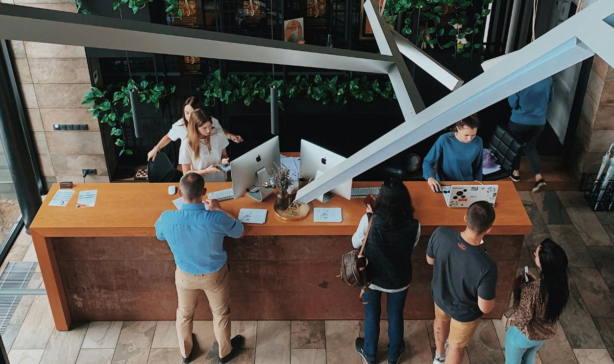 High Angle View on People at the Reception Desk in a Hotel
