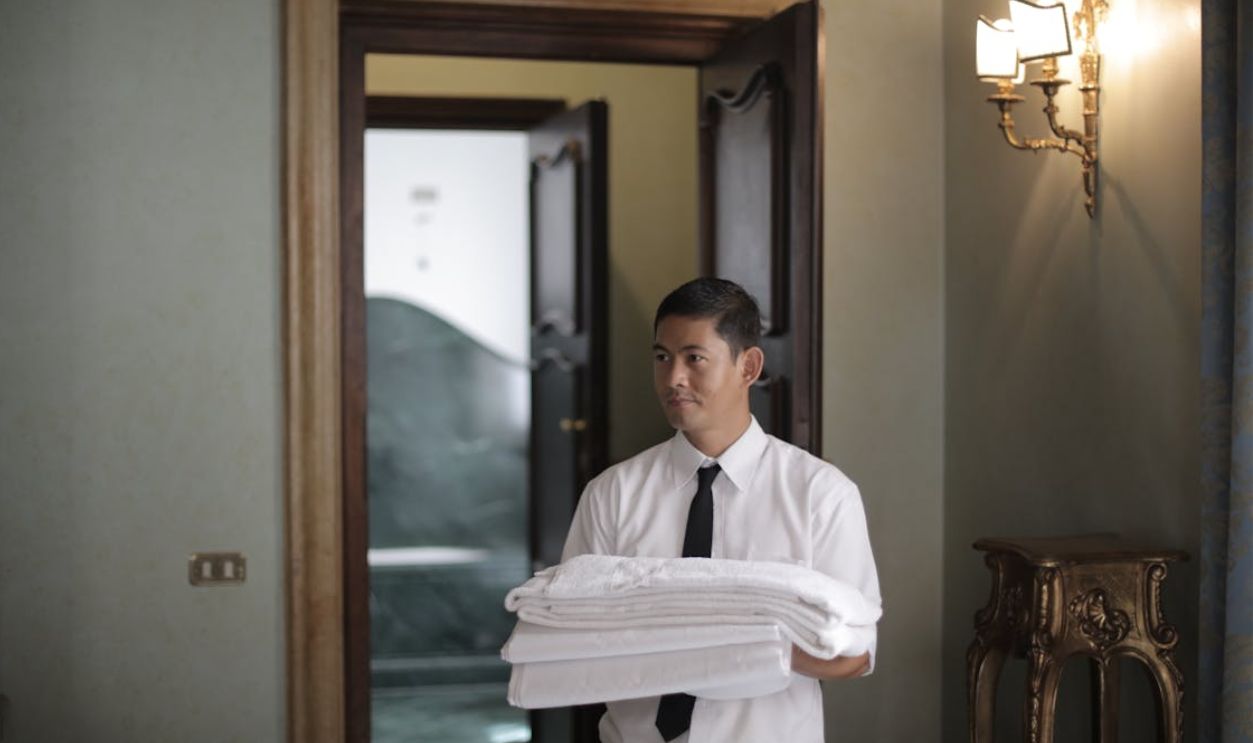 Hotel staff with bed linen