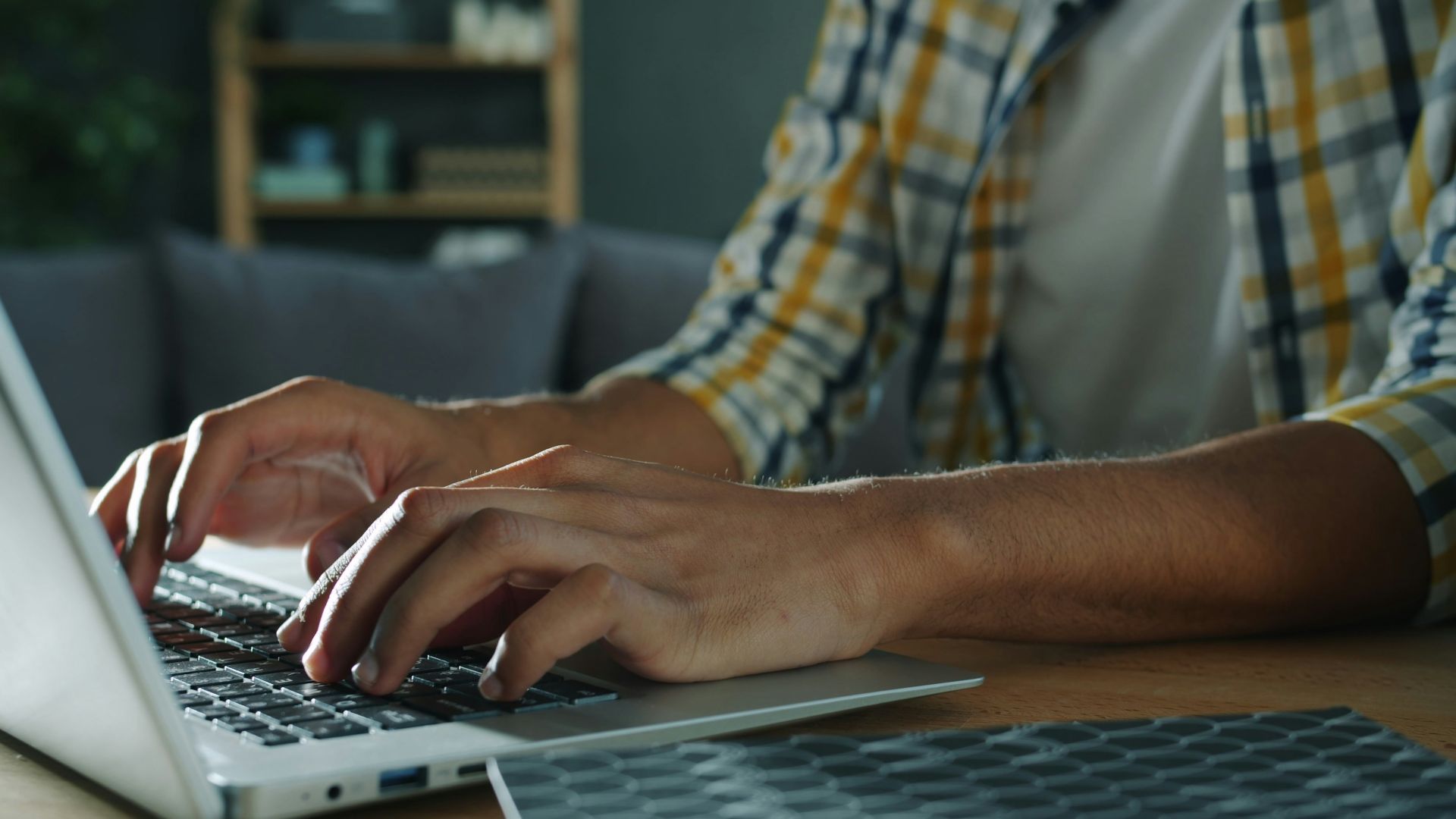 Person typing on a laptop computer indoors
