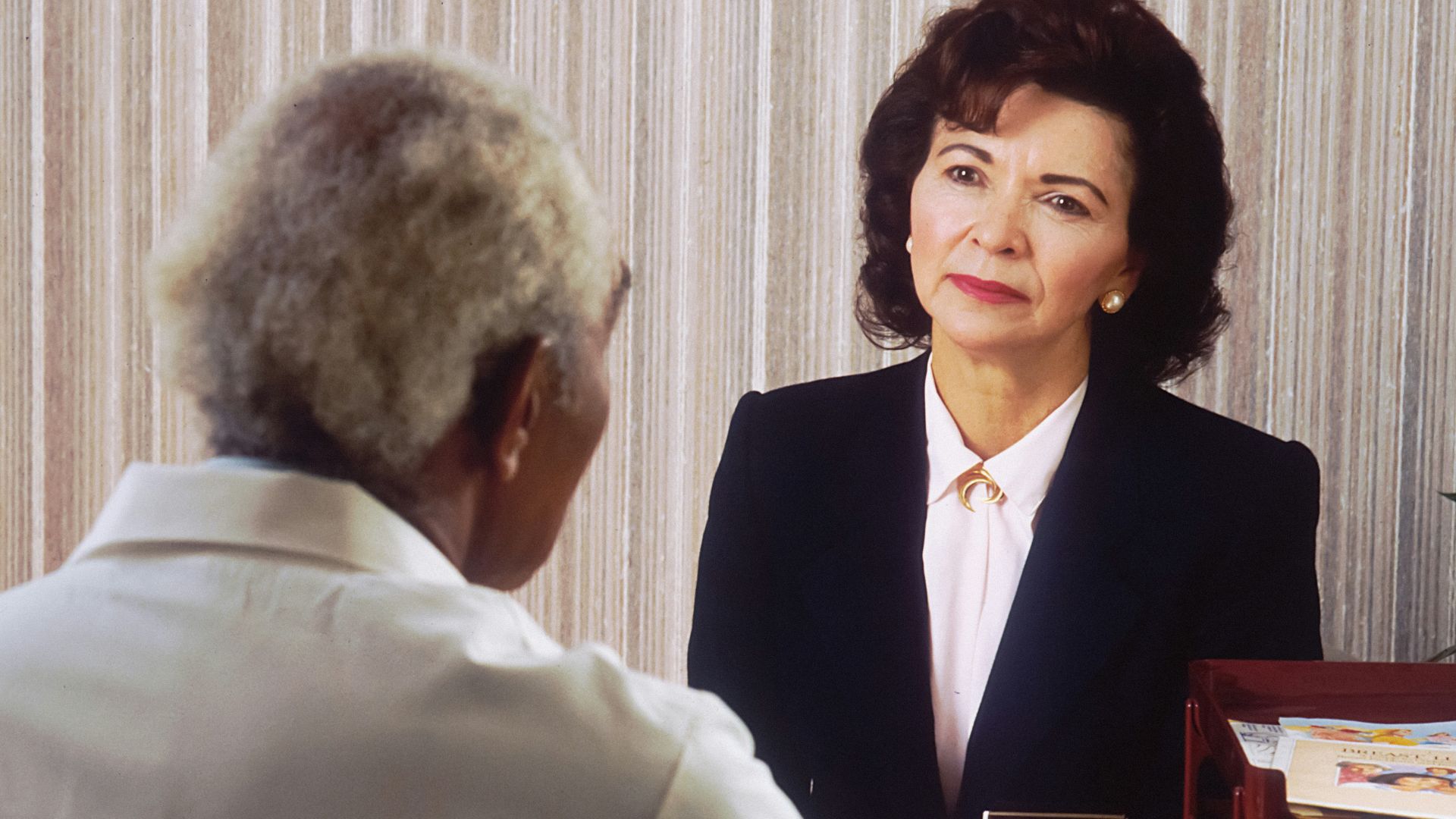 man in black suit jacket standing beside woman in white dress shirt