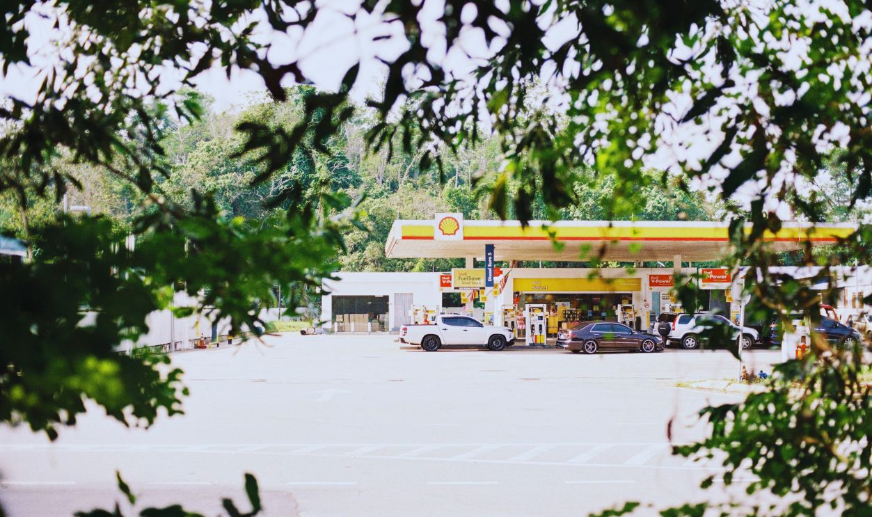 A gas station is seen through the trees