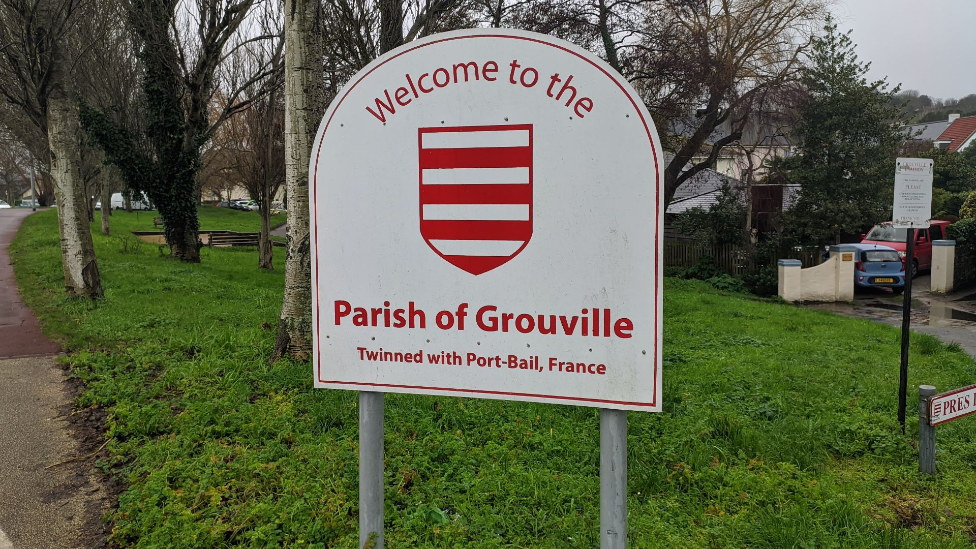 Sign Welcome to the Parish of Grouville Twinned with Port-Bail France Jersey island Channel Gorey village Rue à Don A3 road