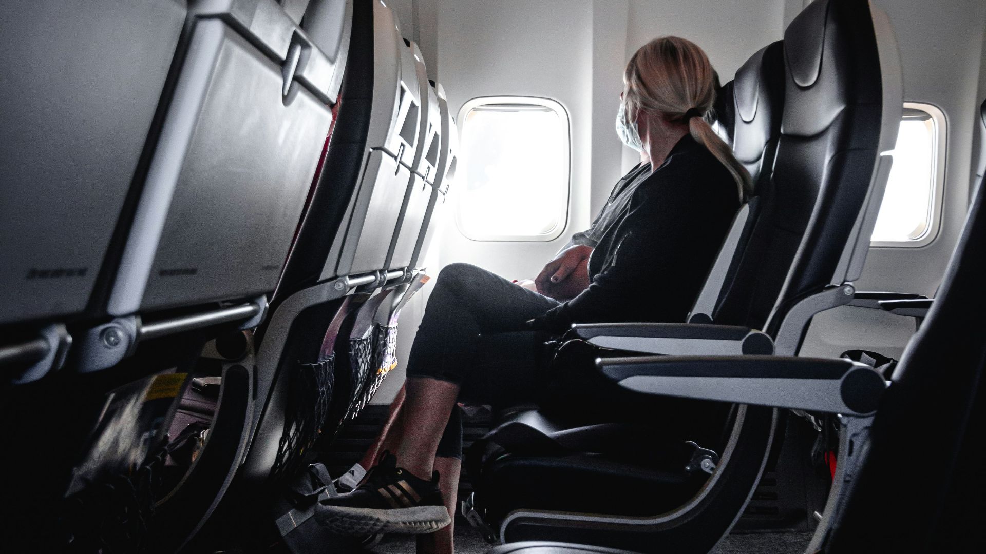 a woman sitting in a seat on an airplane