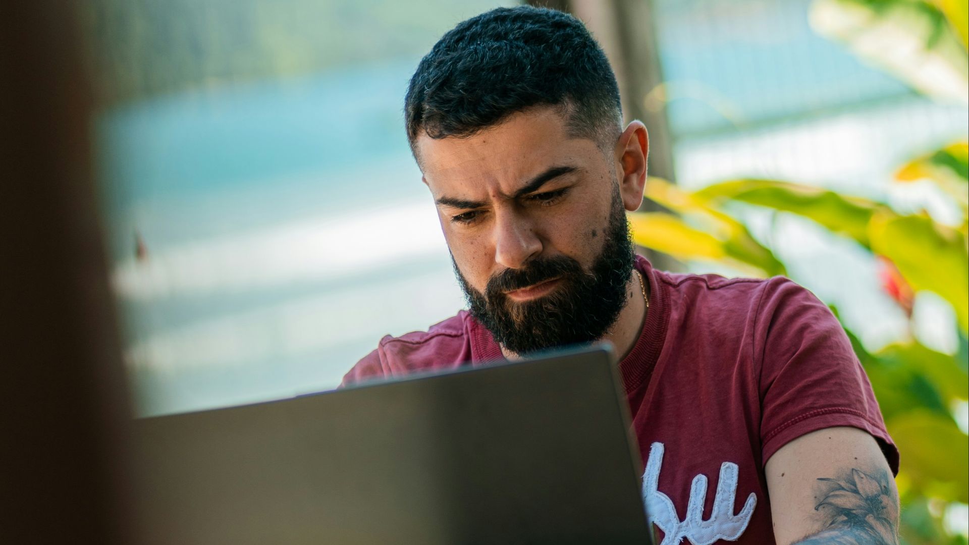 a man with a beard sitting at a table