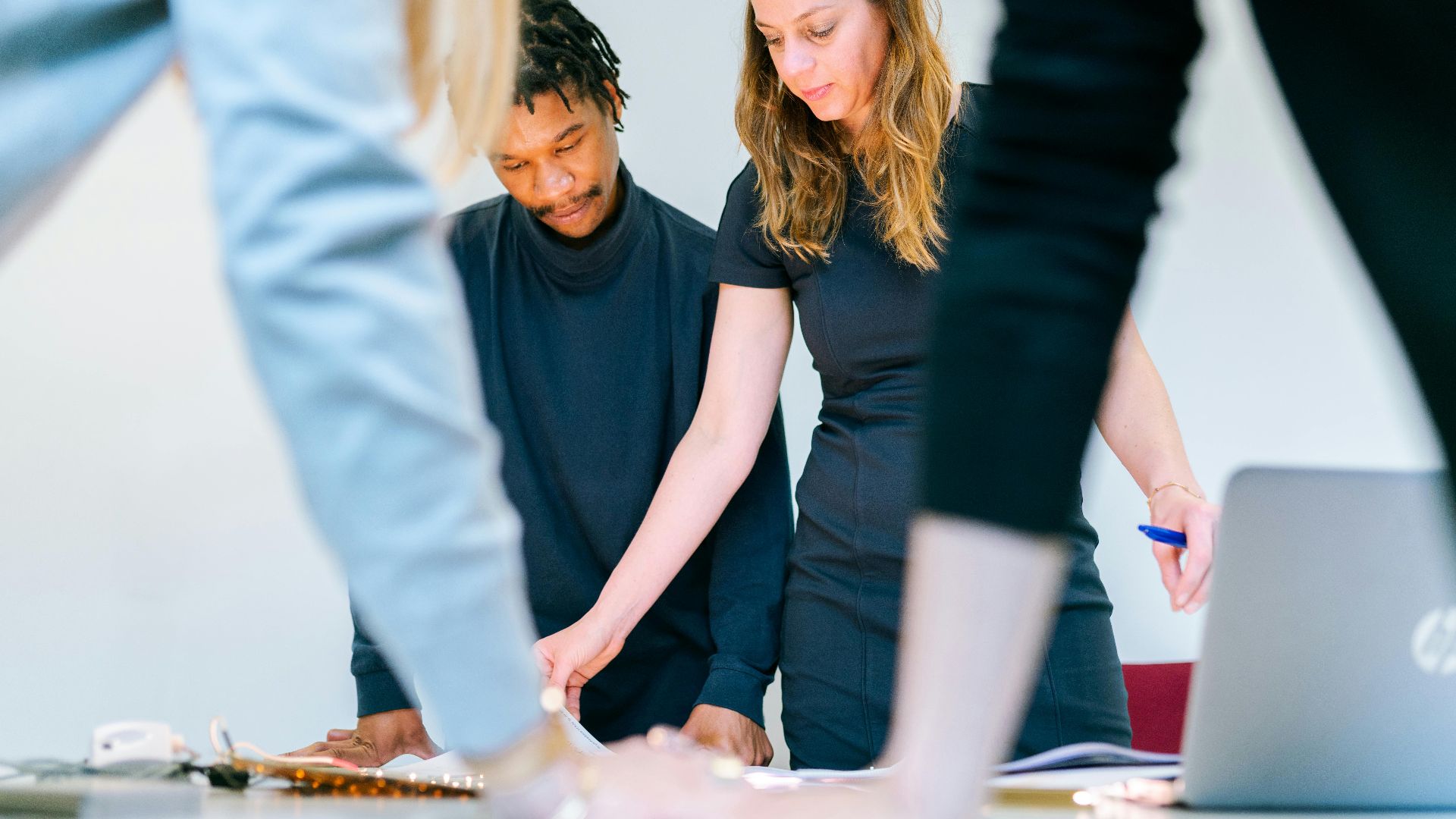 Business professionals engaged in a team meeting in a modern office setting.