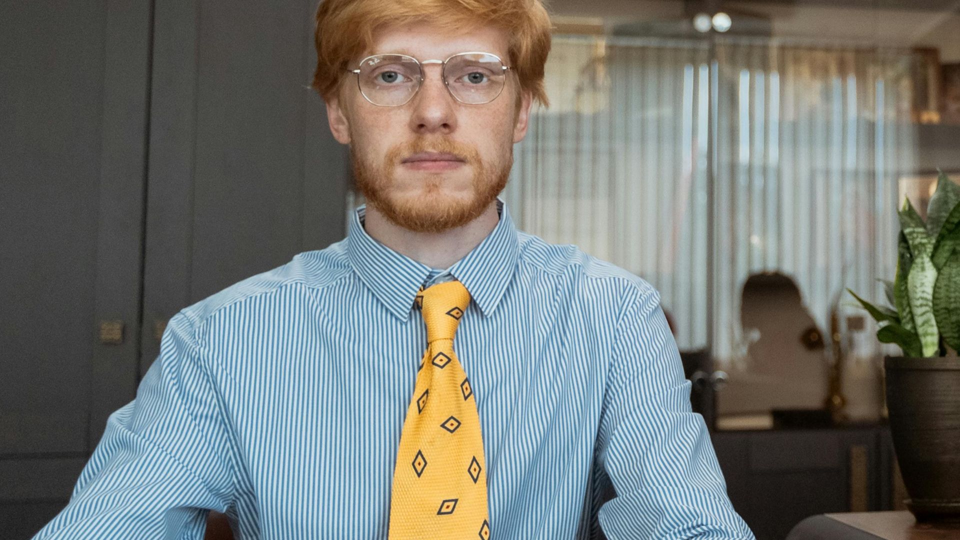 Two professionals in a retro office setting sharing a workspace.