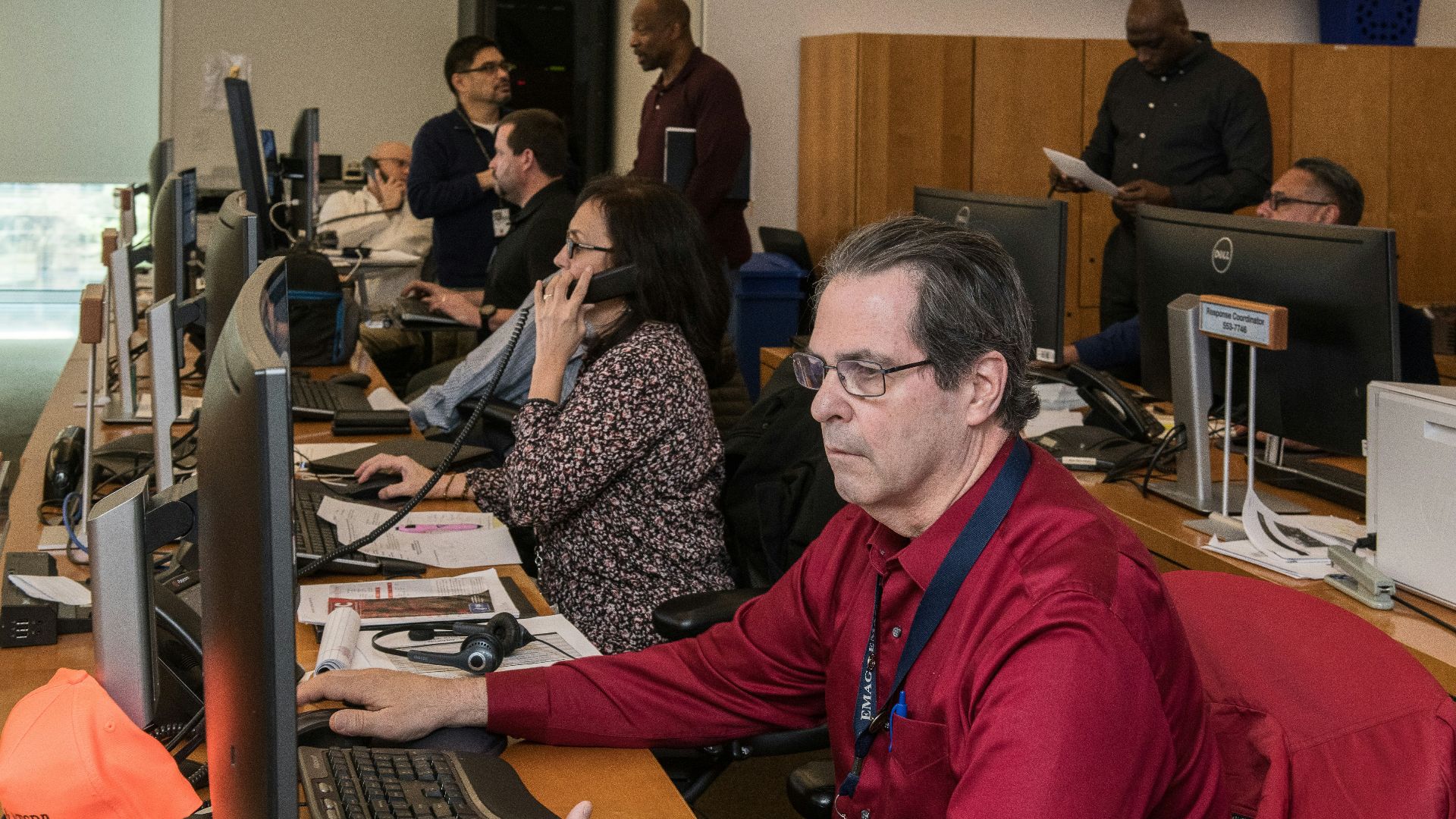 man in red jacket sitting beside woman in black and white long sleeve shirt