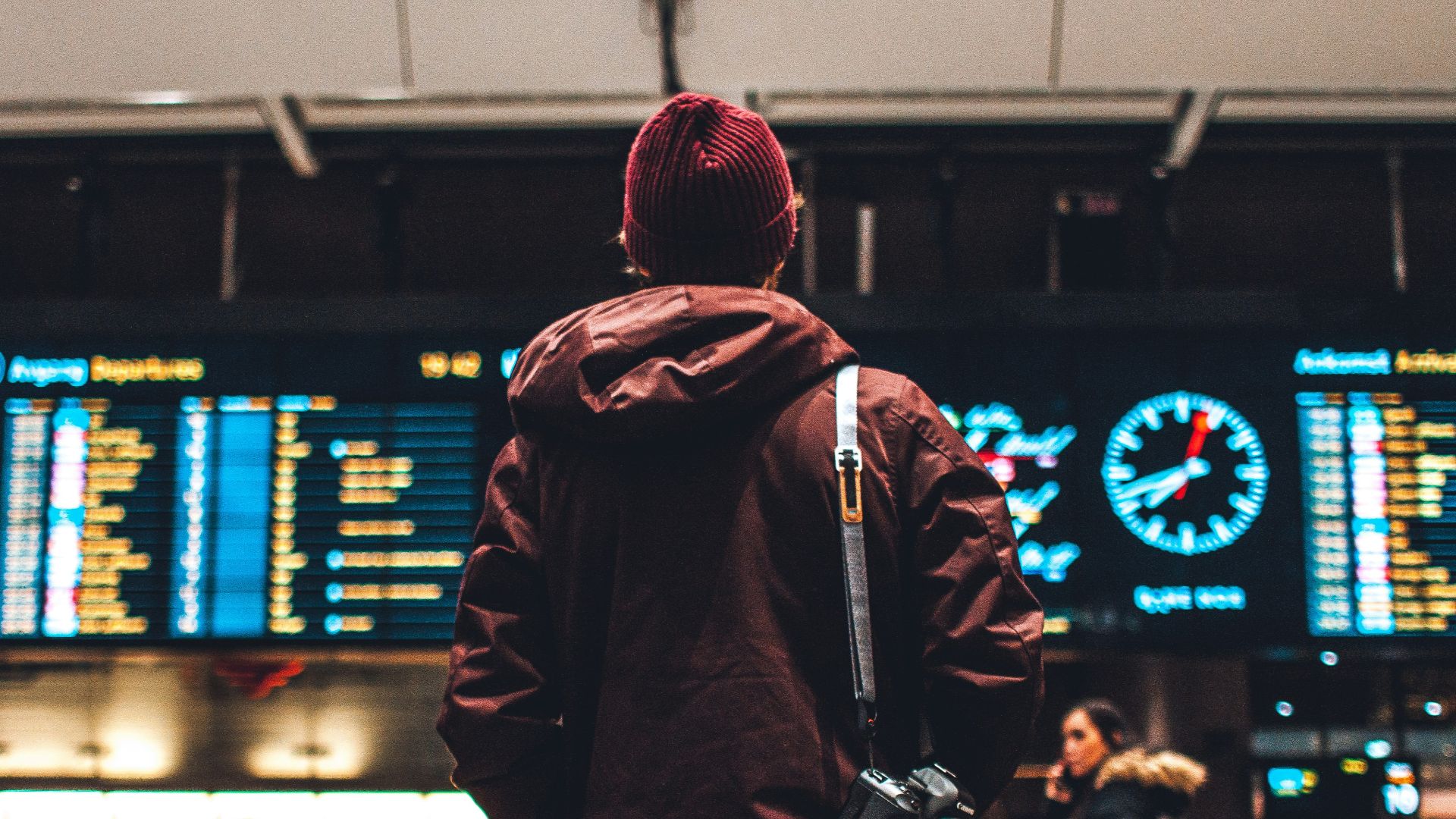 person looking up to the flight schedules
