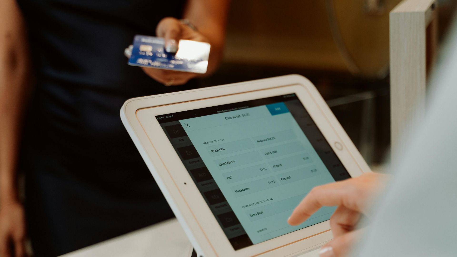 A modern cashless payment system using a tablet and card for seamless transactions.