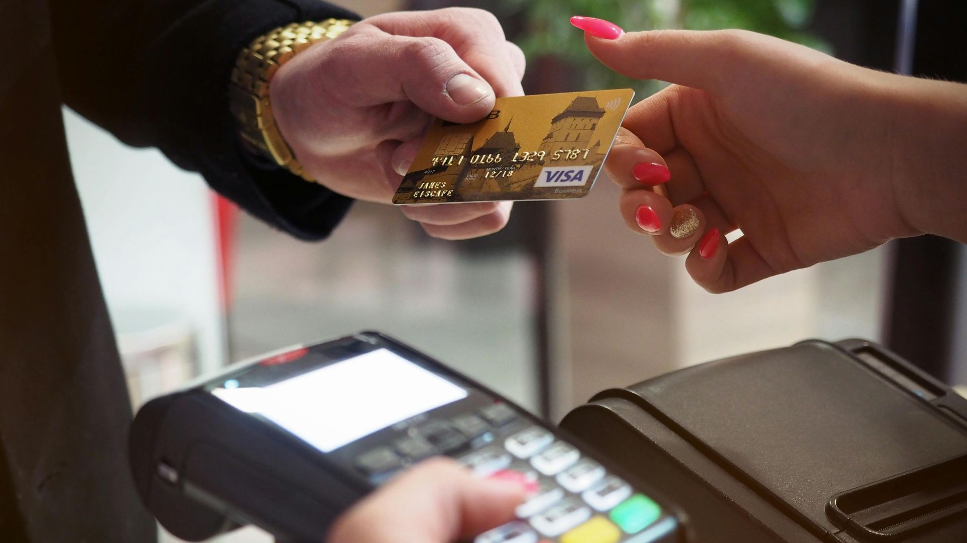 Close-up of a credit card payment being processed at a POS terminal.