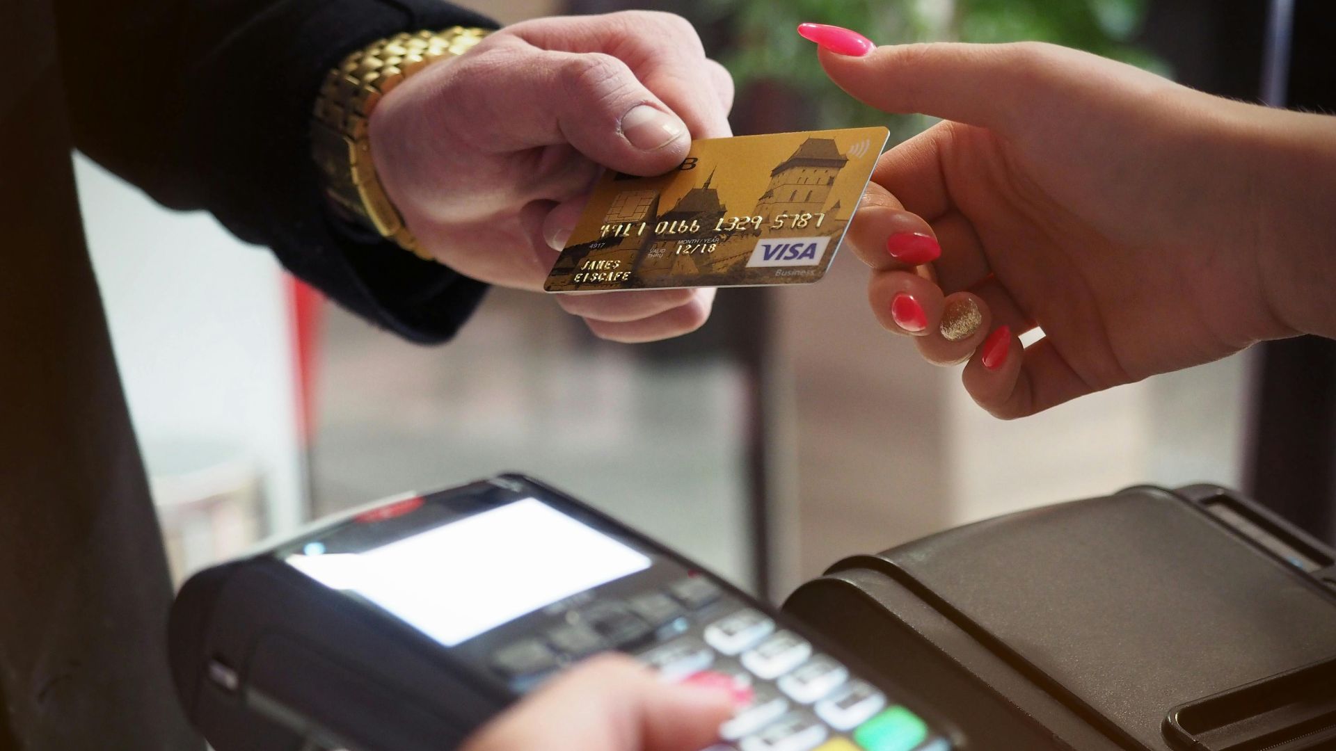 Close-up of a credit card payment being processed at a POS terminal.