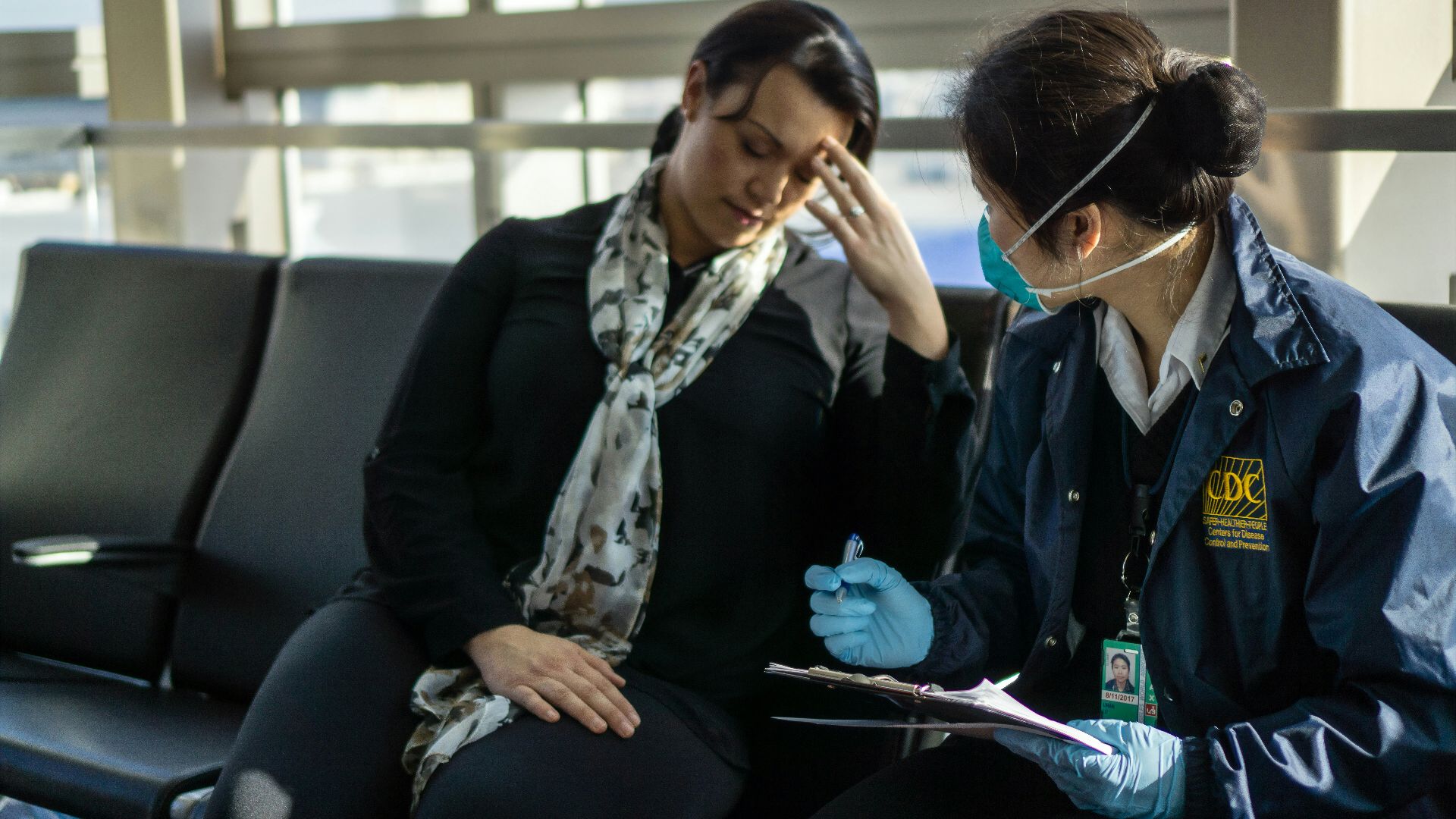 woman in black blazer sitting on black sofa