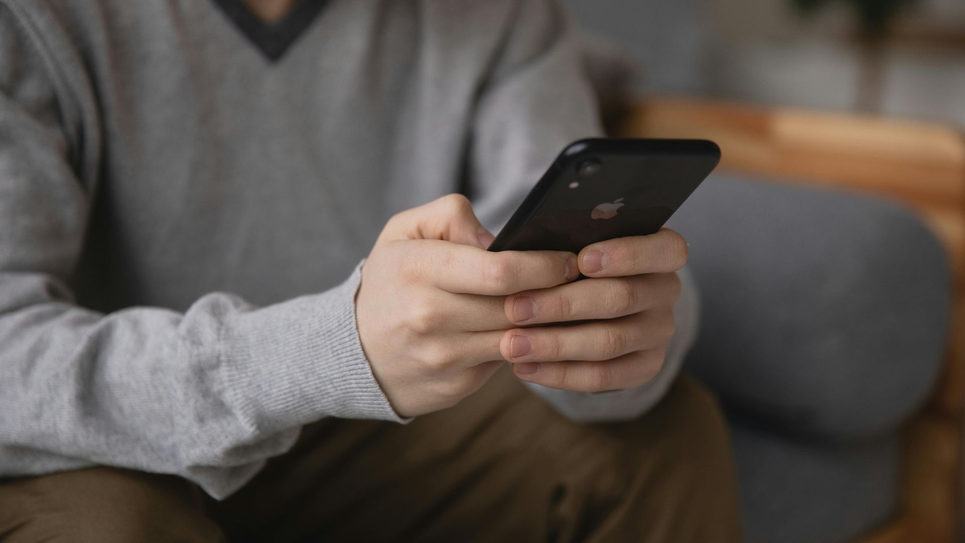 Person holding a smartphone, focusing on connectivity and modern technology.