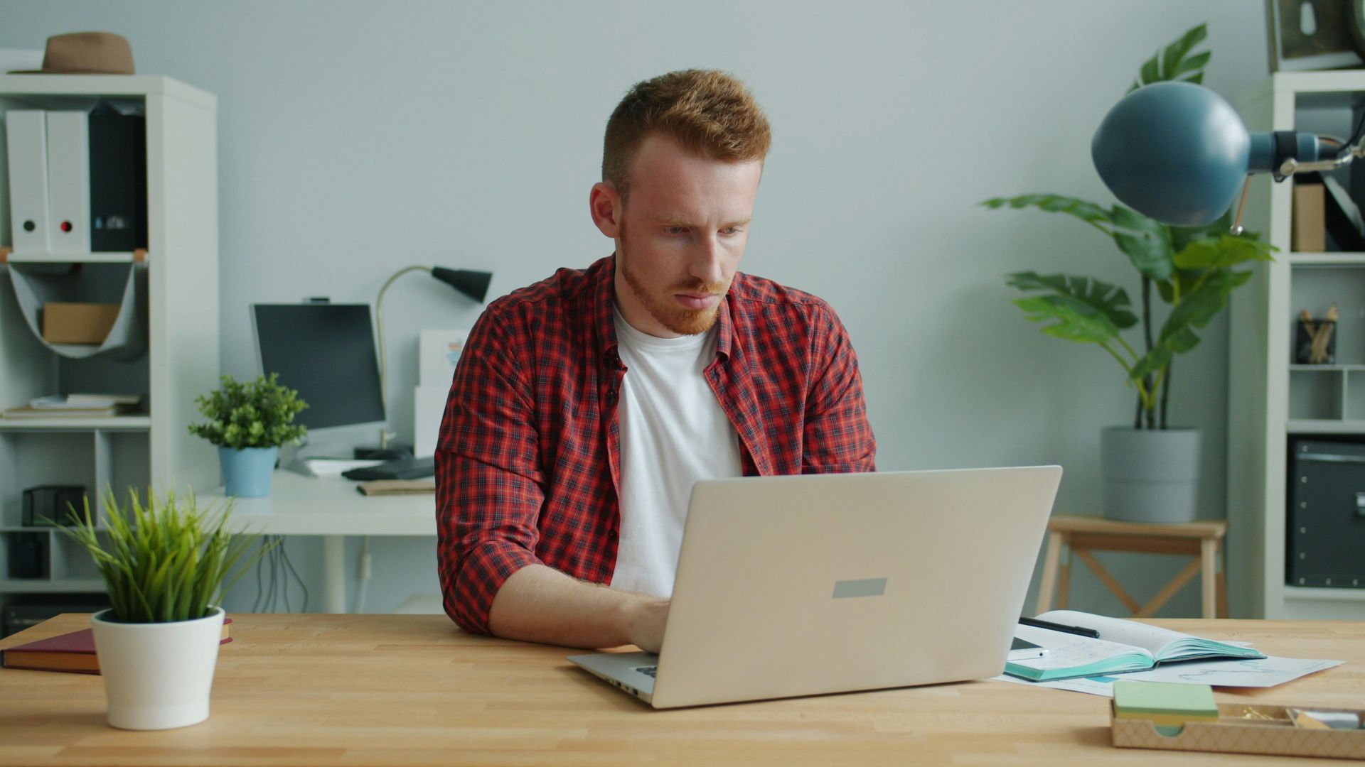 Man working on a laptop at a desk.