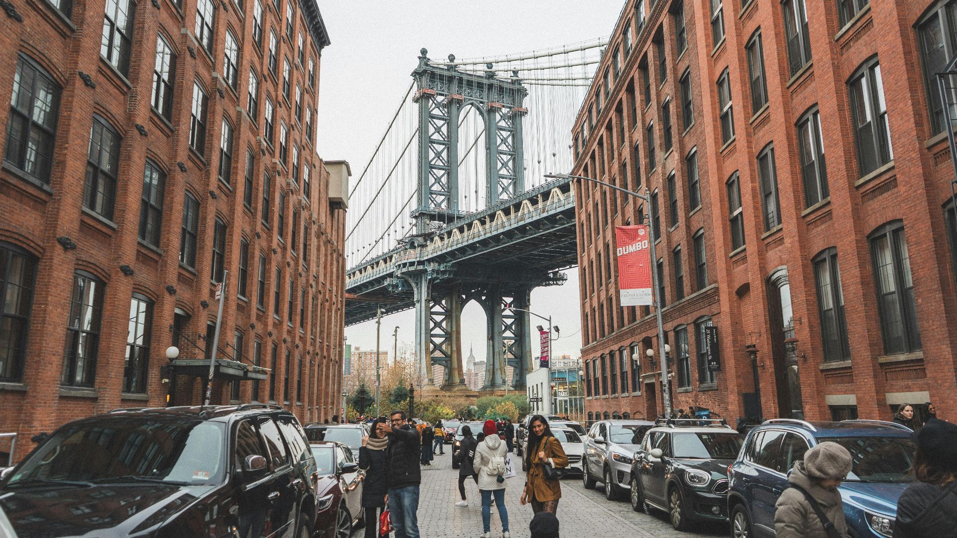 Scenic view of the Manhattan Bridge framed by urban architecture in DUMBO, Brooklyn, NYC.