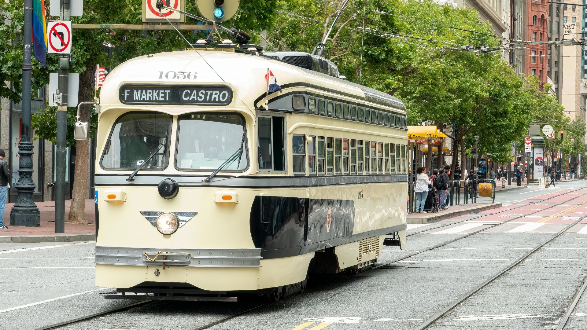 A charming streetcar travels through San Francisco's bustling cityscape on the F Market & Castro line.