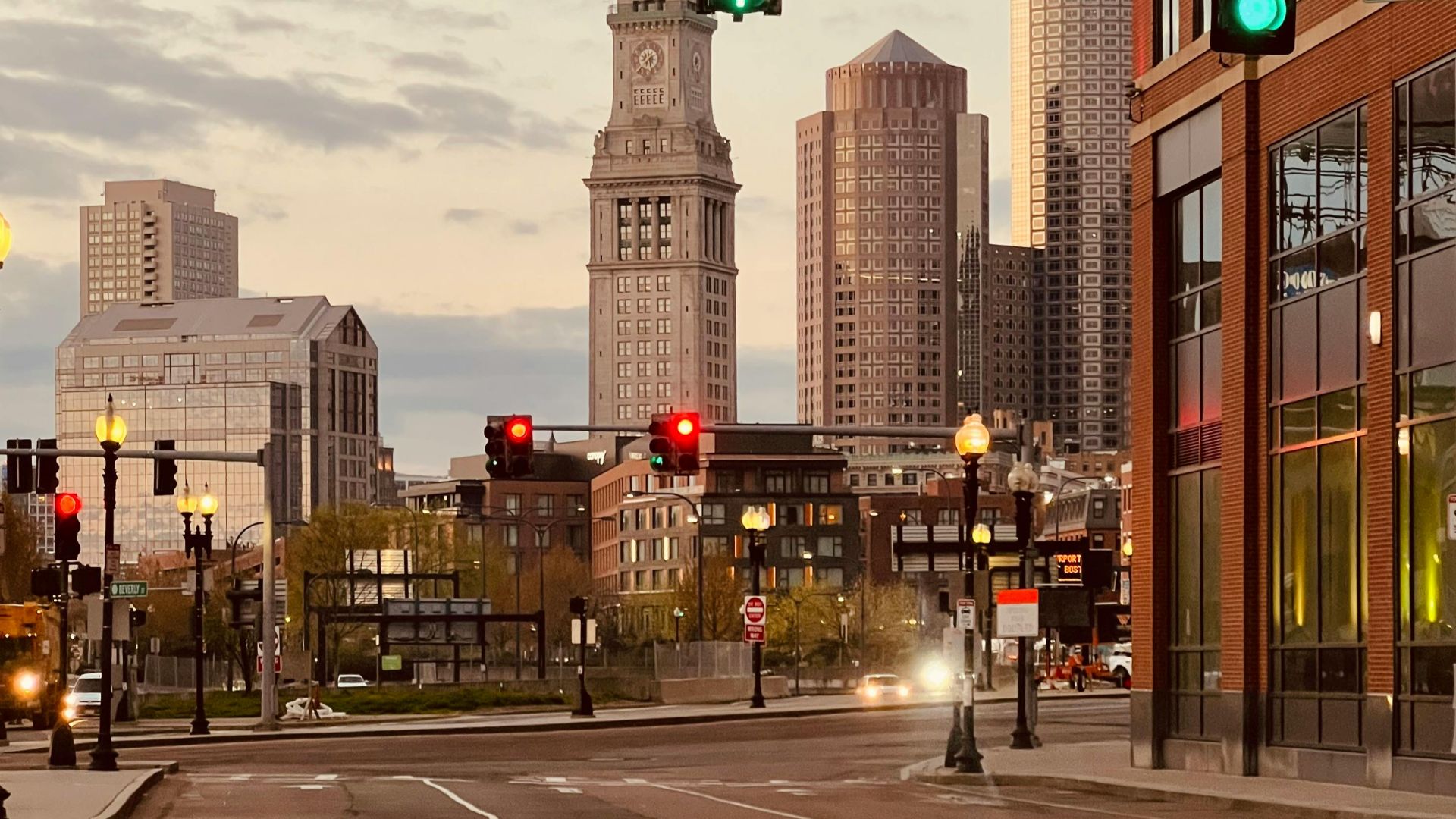 Iconic view of Boston's Custom House Tower at sunset with urban cityscape.