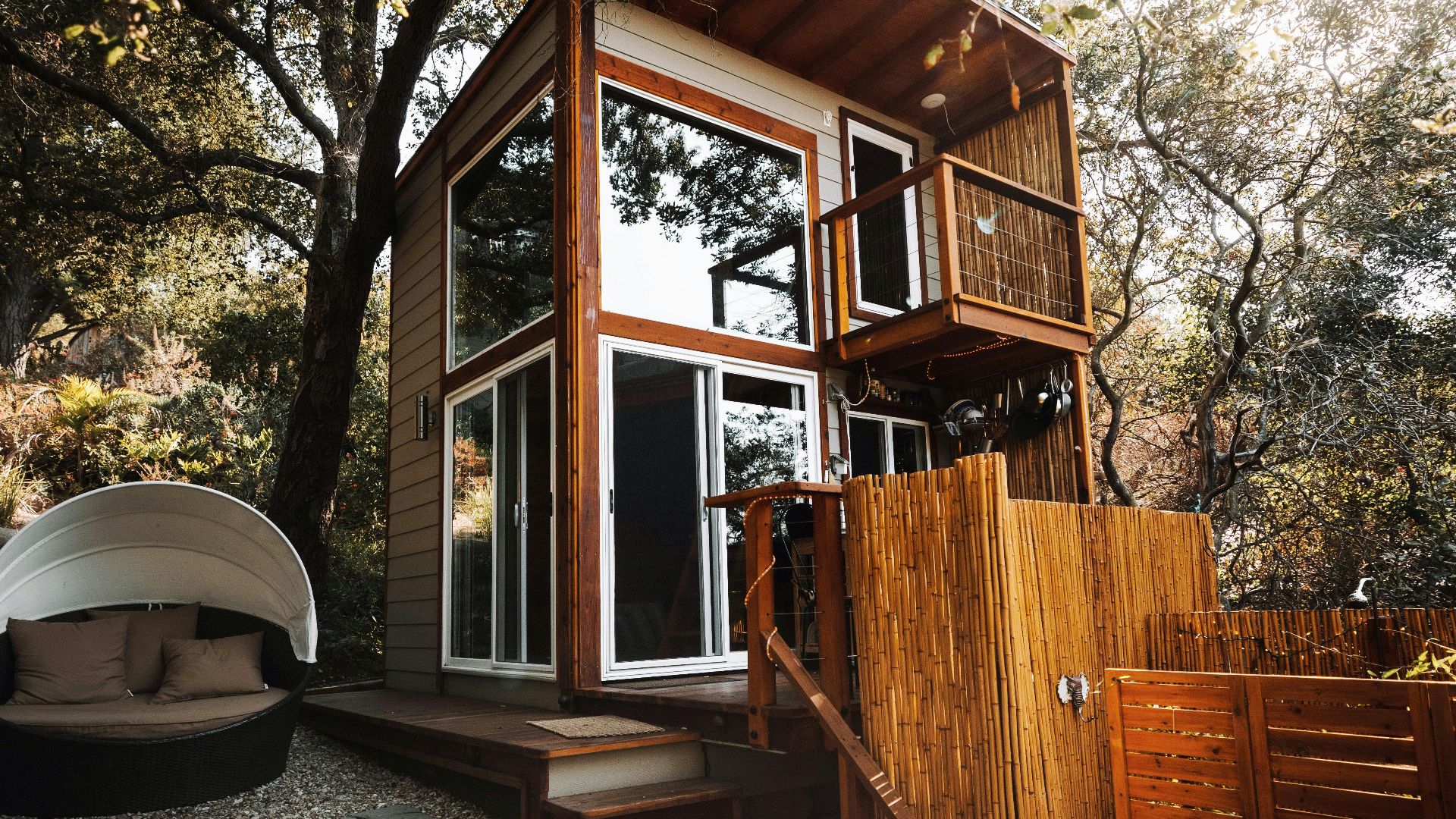 A stylish wooden cabin amidst green foliage, ideal for a serene getaway.