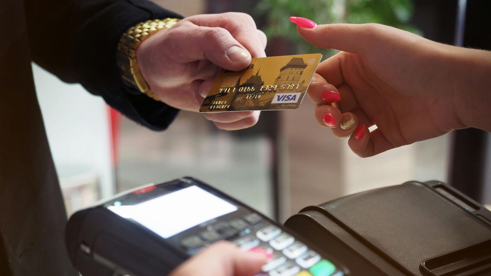 Close-up of a credit card payment being processed at a POS terminal.