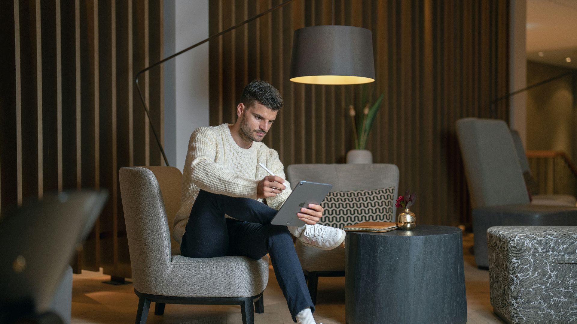 a person sitting in a chair with a laptop