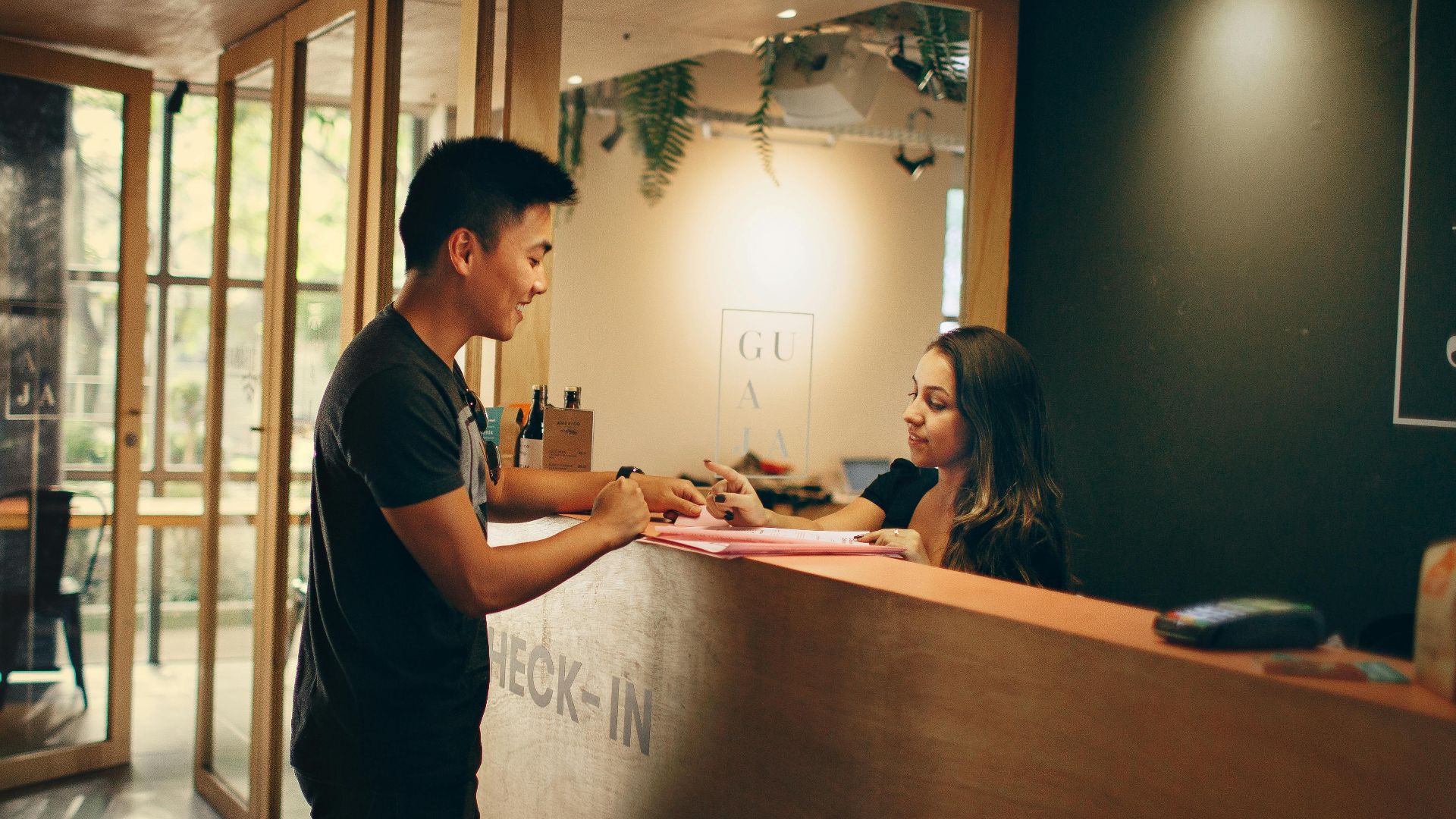 A customer checks in at a hotel reception desk in Belo Horizonte, Brazil.