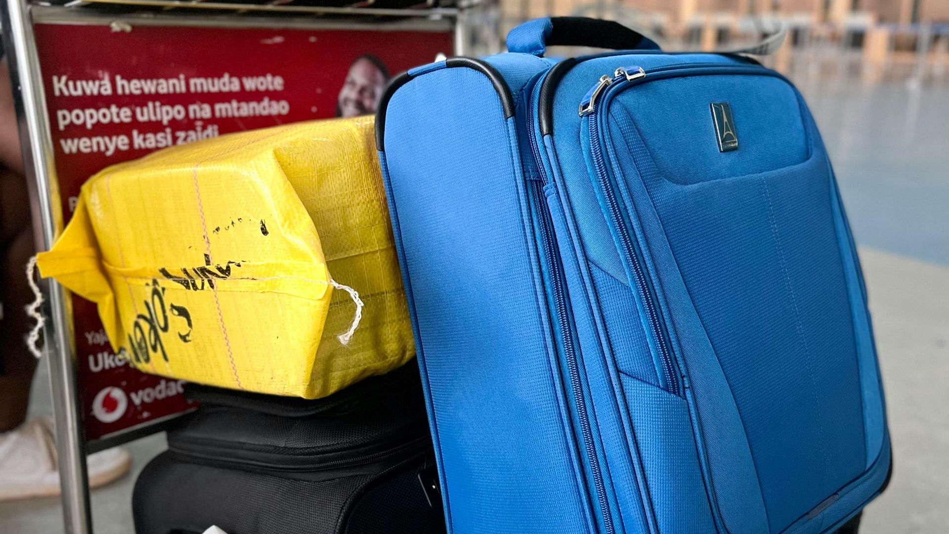 Luggage on trolley in Dar es Salaam Airport, Tanzania, showcasing travel preparation and mobility.