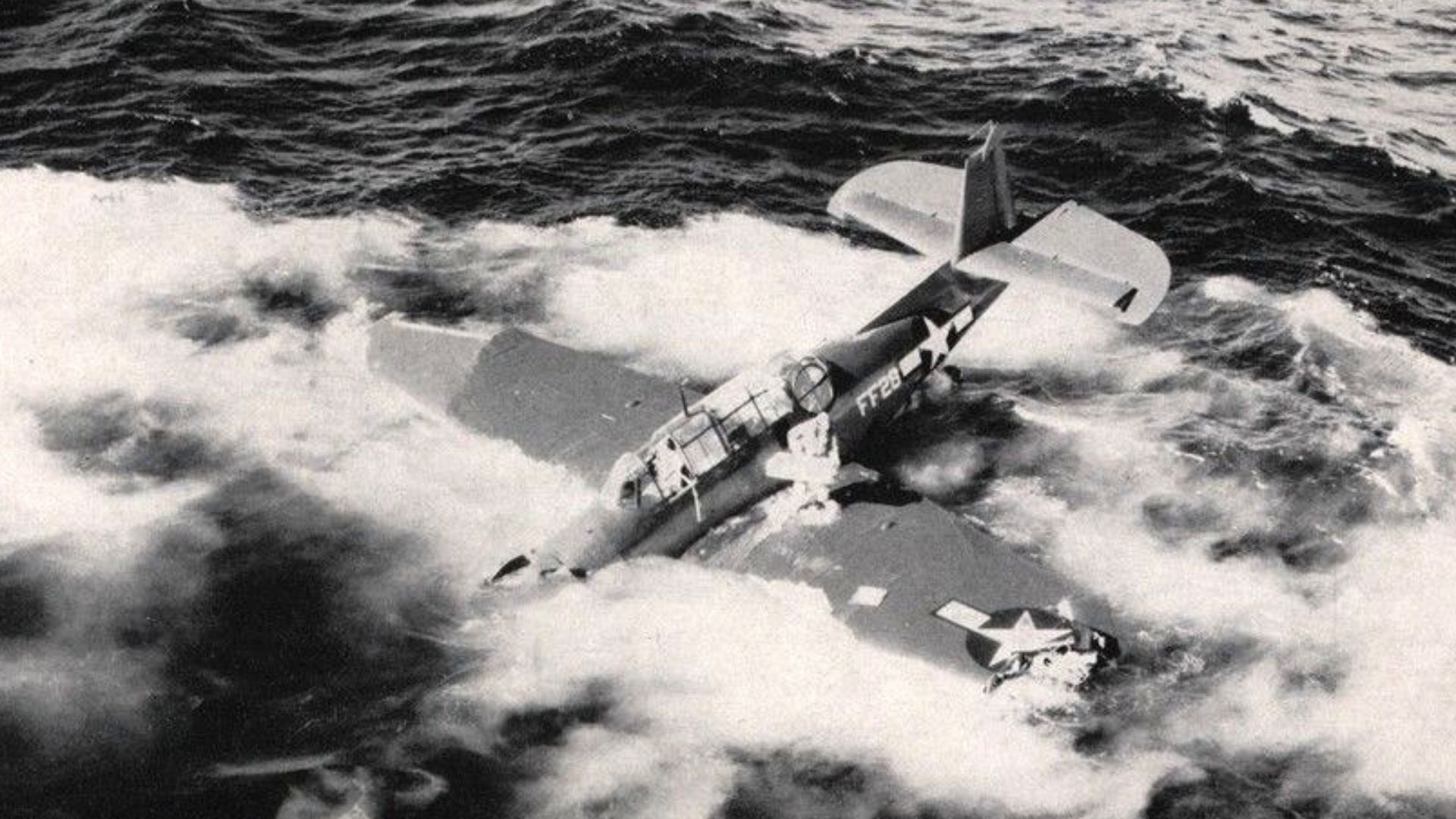 View of a U.S. Navy Grumman TBF Avenger that made a water landing next to the light cruiser USS USS San Juan (CL-54), circa in 1944.