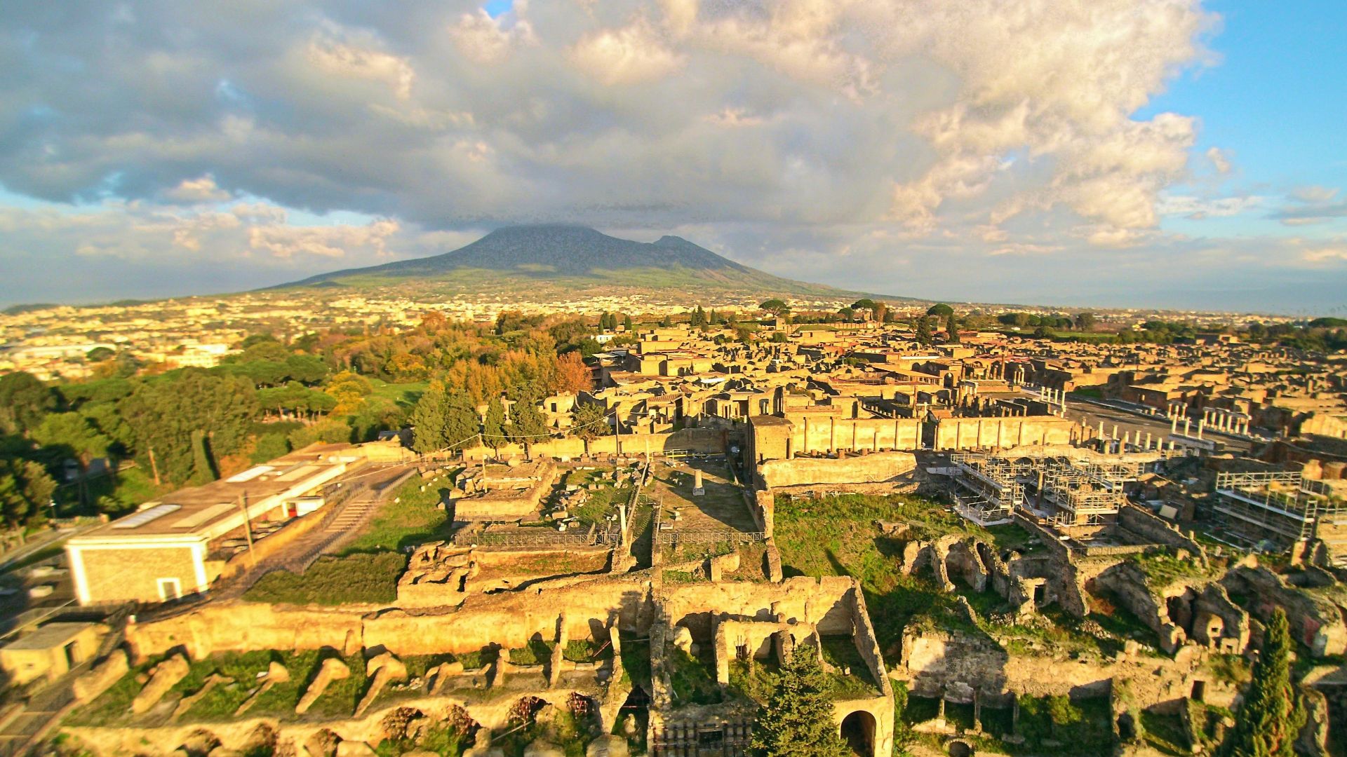 Ruins of Pompeii seen from the above with a drone, with the Vesuvius in the background.