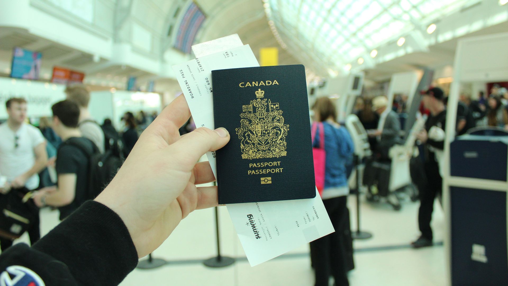 person holding Canada passport