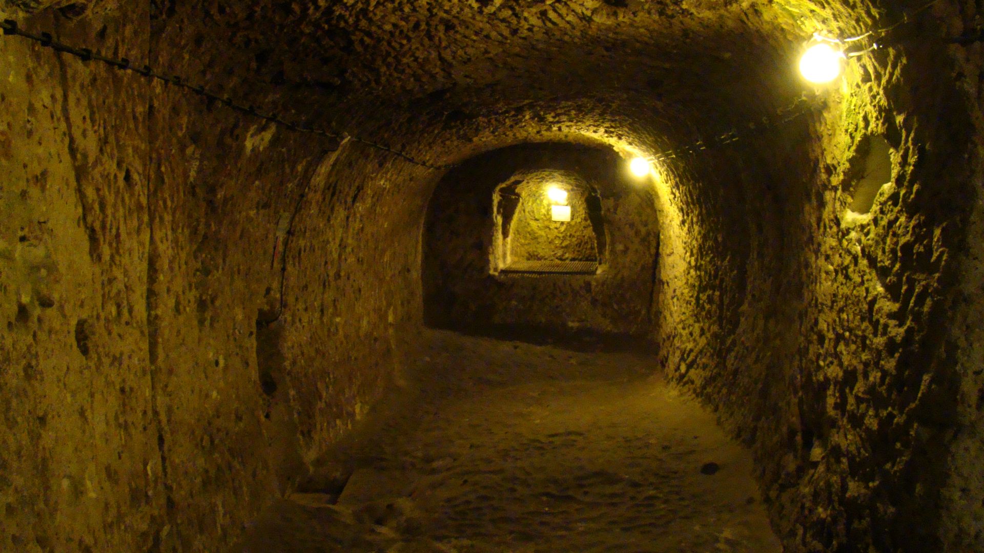 A typical view from inside the underground city in Derinkuyu, one of the largest underground complexes in Cappadocia. There are few artifacts left from the original builders, mainly just large rocks that was used to block the passage for intruders. 
Most of the