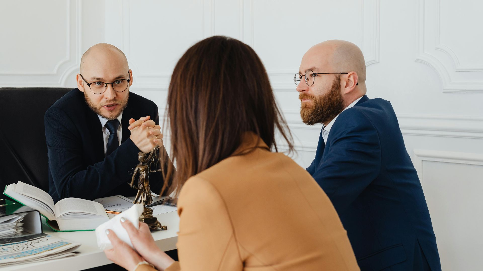 Professional discussion among lawyers in a modern office, focusing on legal matters.