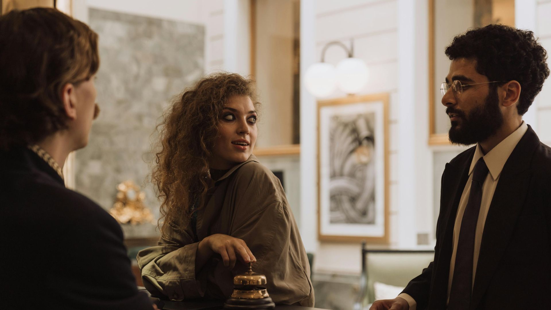 Guests interacting at a luxurious hotel reception desk, emphasizing hospitality and service.