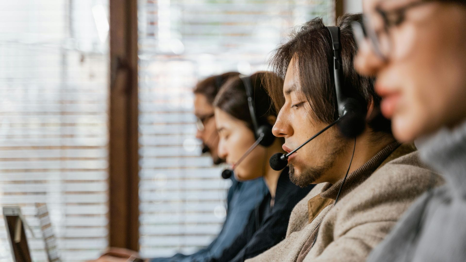 Call center employees working diligently with headsets, offering dedicated customer service.