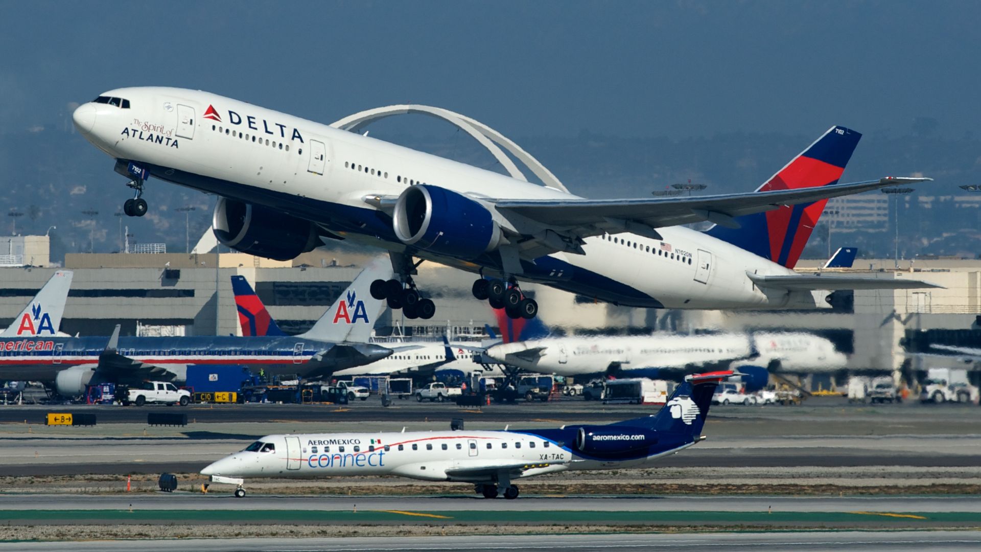 The Spirit of Atlanta departing LAX. AeroMexico Connect ERJ-145 XA-TAC waiting to taxi.