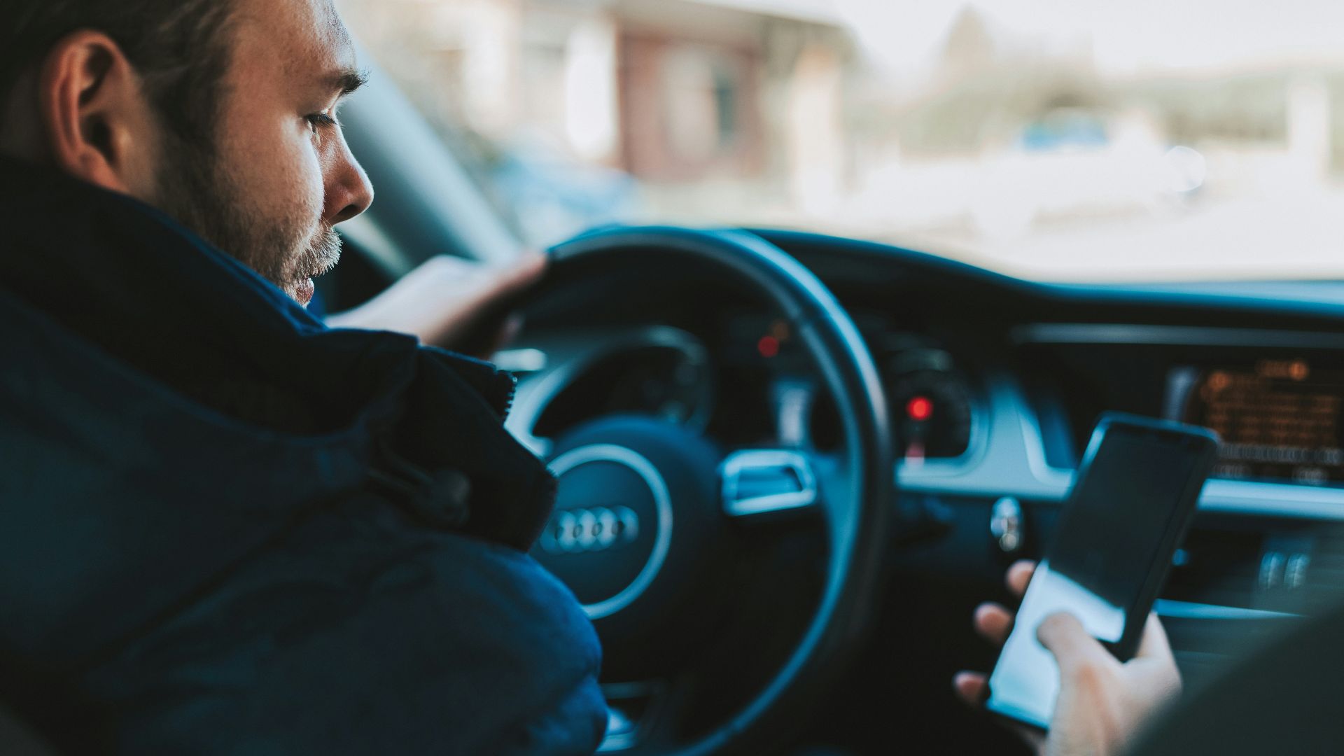 man holding black smartphone