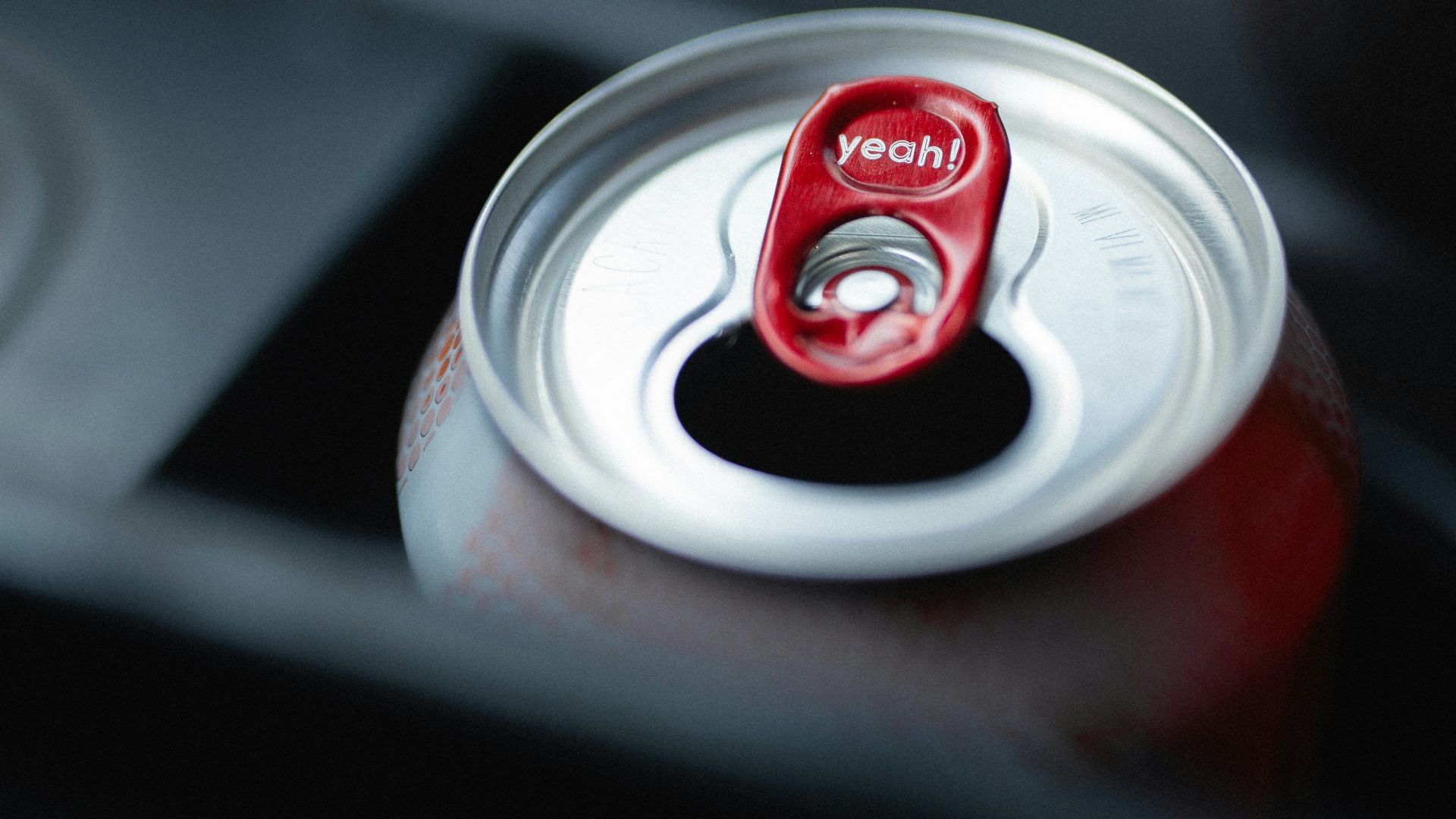 a can of soda sitting on top of a table