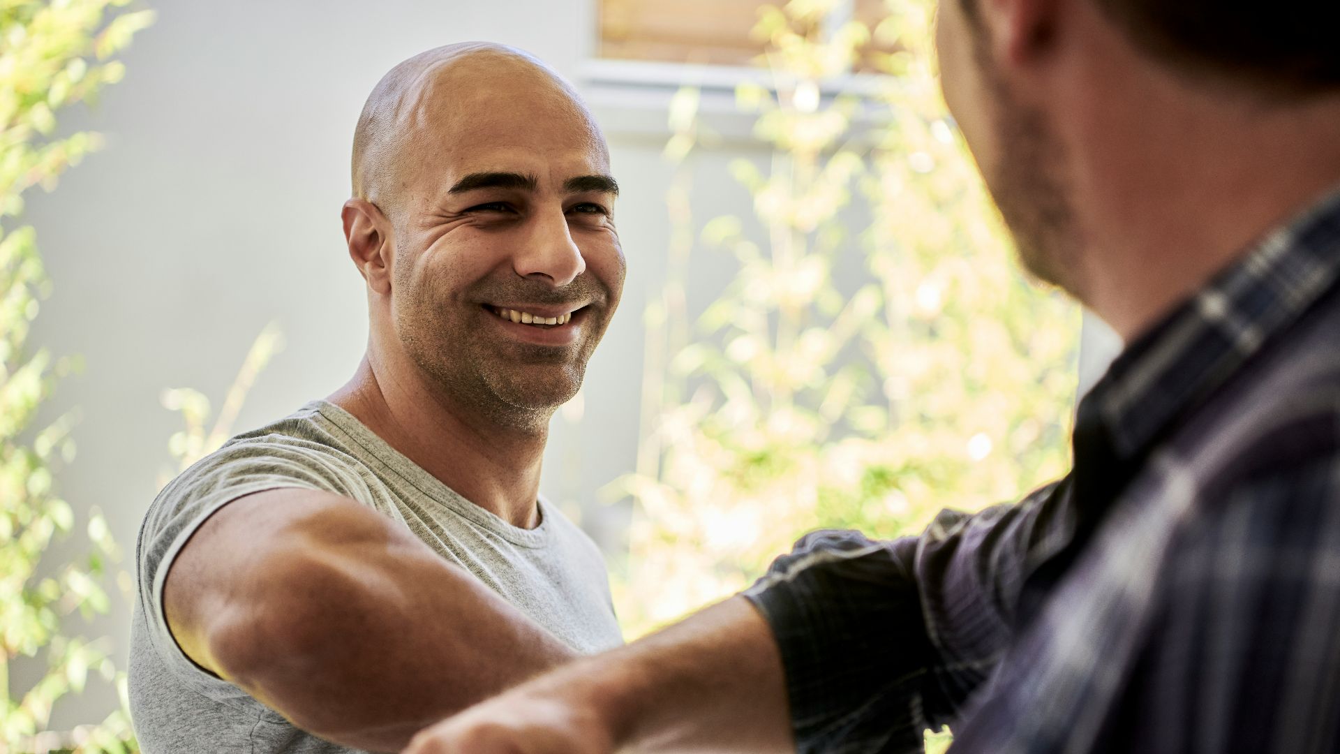 two men elbow bumping
