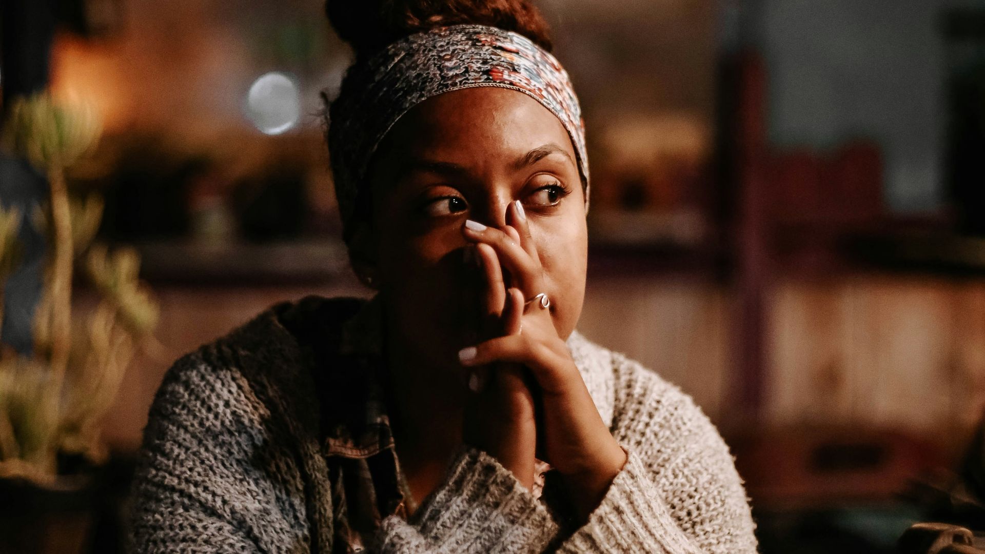 man in black and white sweater sitting on chair