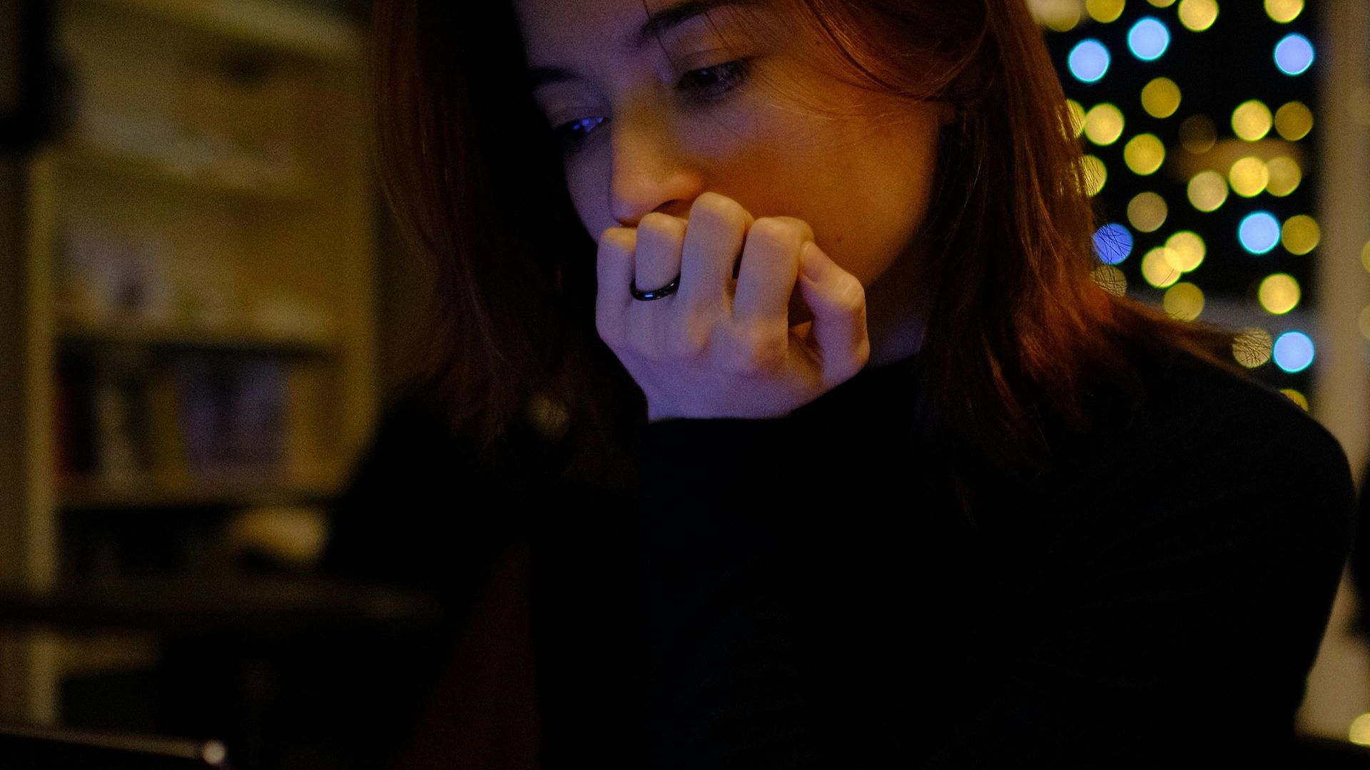A woman sitting in front of a laptop computer