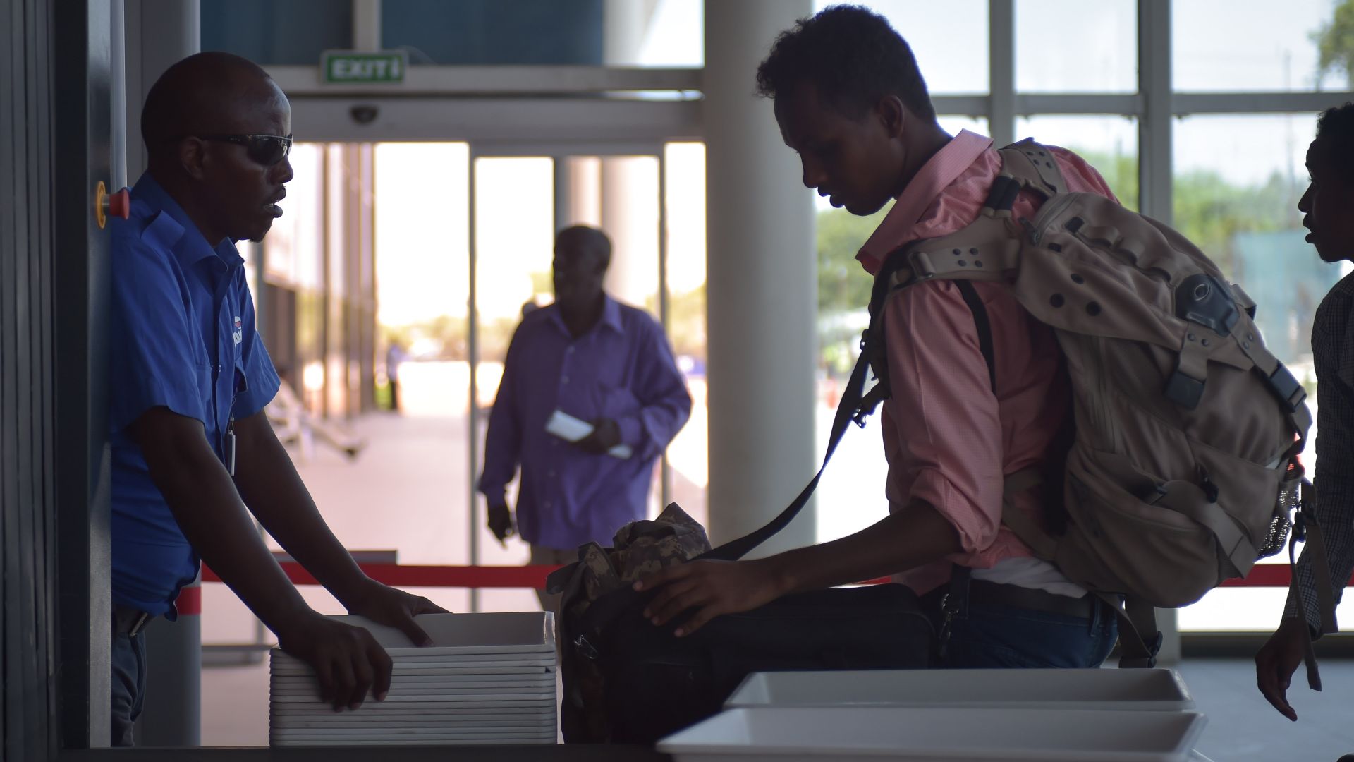 A passenger removes his luggage to be scanned through an x-ray machine at Mogadishu's Aden Adde International Airport in Somalia on April 19. After an explosion ripped a hole in the side of a Daalo Airline's airplane in February of 2016, security at Aden Adde International Airport has been drastically revamped in order to ensure similar incidents do not occur. AMISOM Photo / Tobin Jones