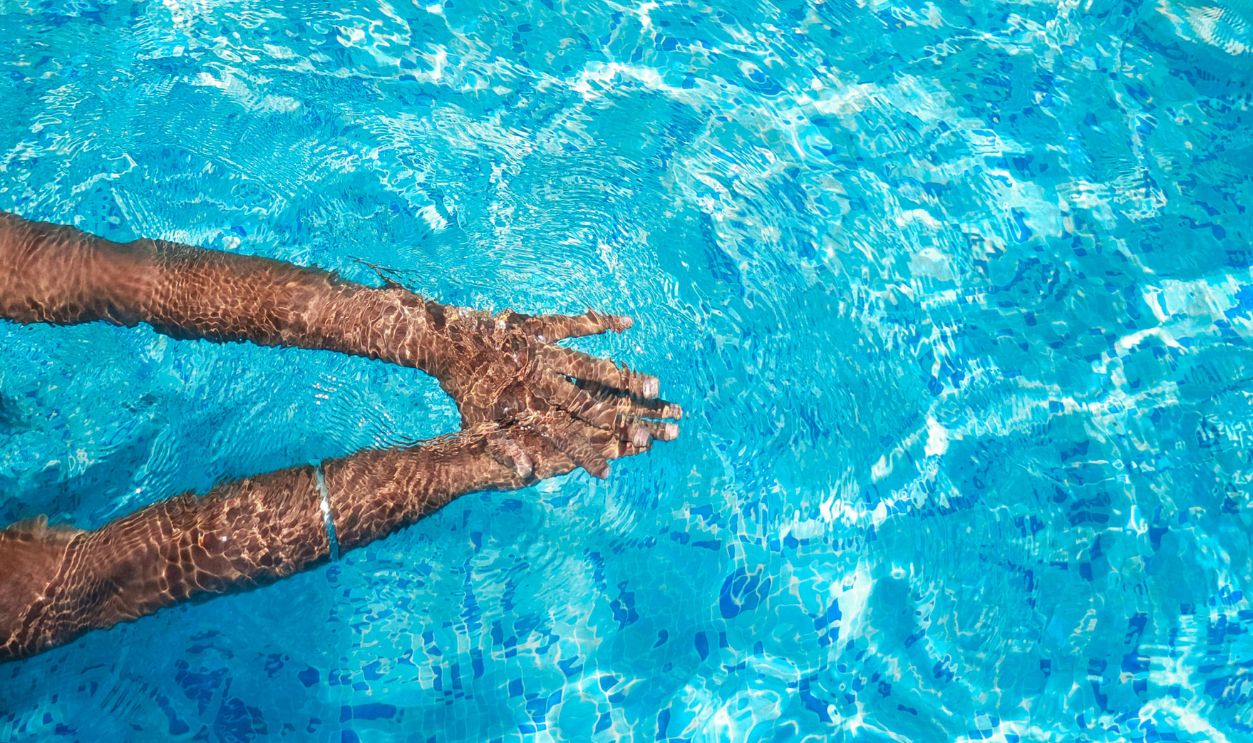 Hands of Swimmer in Swimming Pool