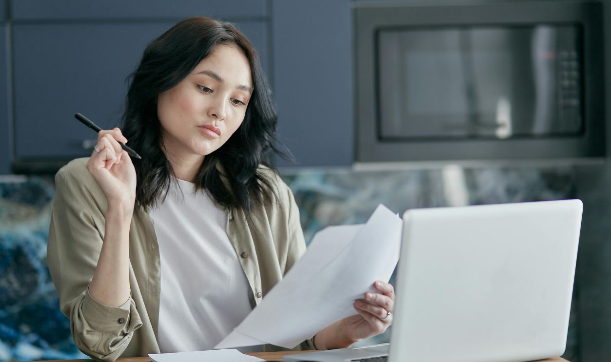 A Woman Looking at White Papers