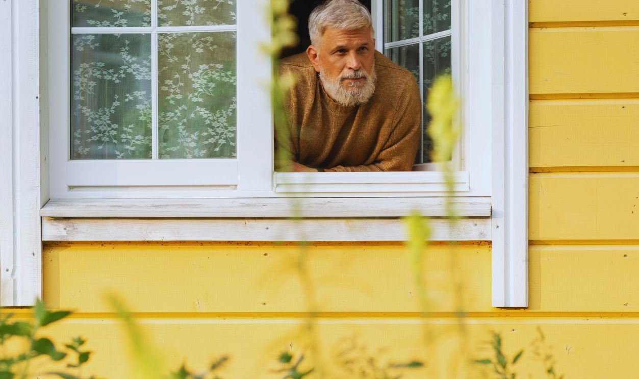 Elderly Man Leaning out of Window