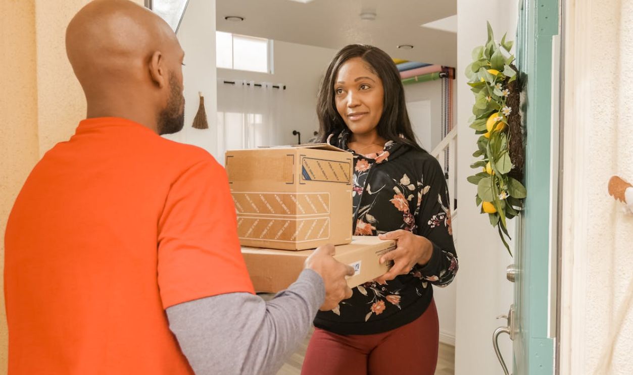 A Woman Receiving Boxes from a Person