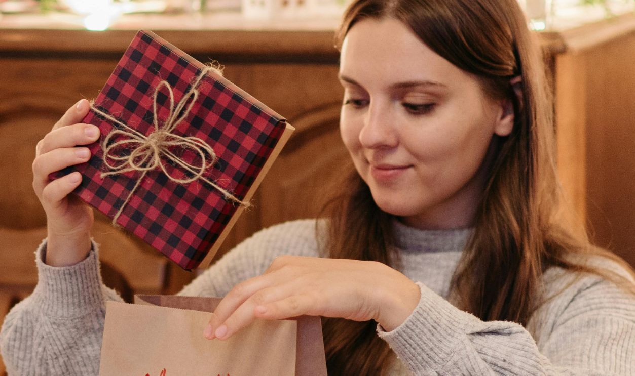 A Woman Putting a Gift in the Paper Bag