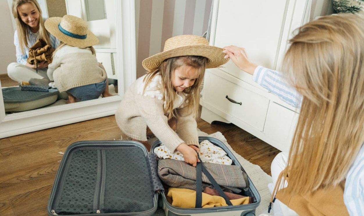 Woman in Beige Long Sleeve Shirt and Brown Hat Sitting on Black Chair