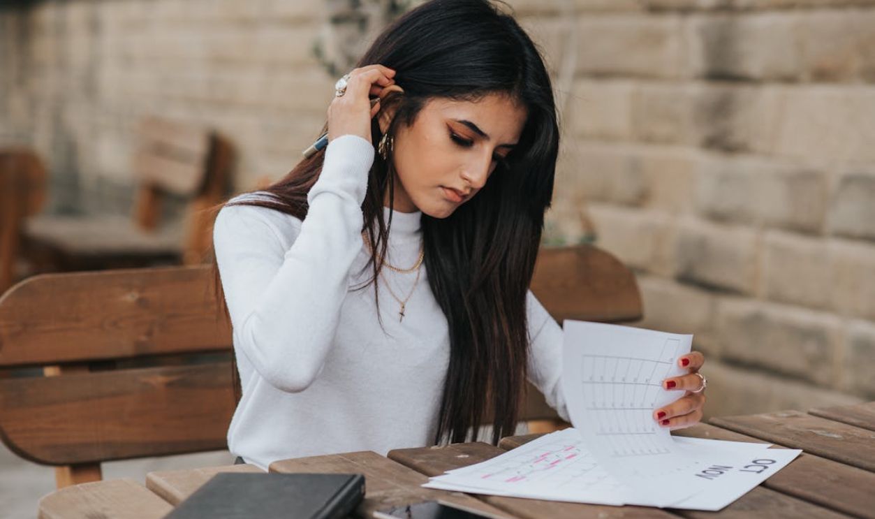 Ethnic young woman reading notes