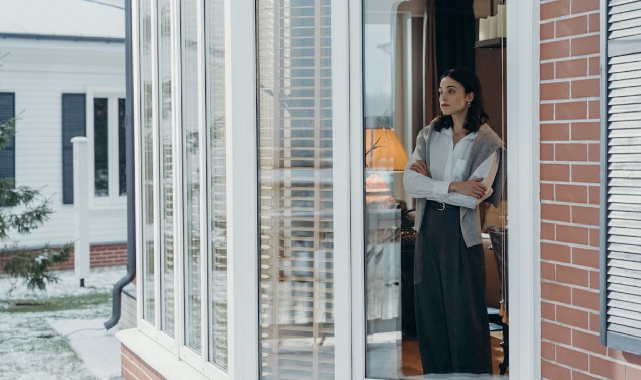 A Woman Standing Behind the Window