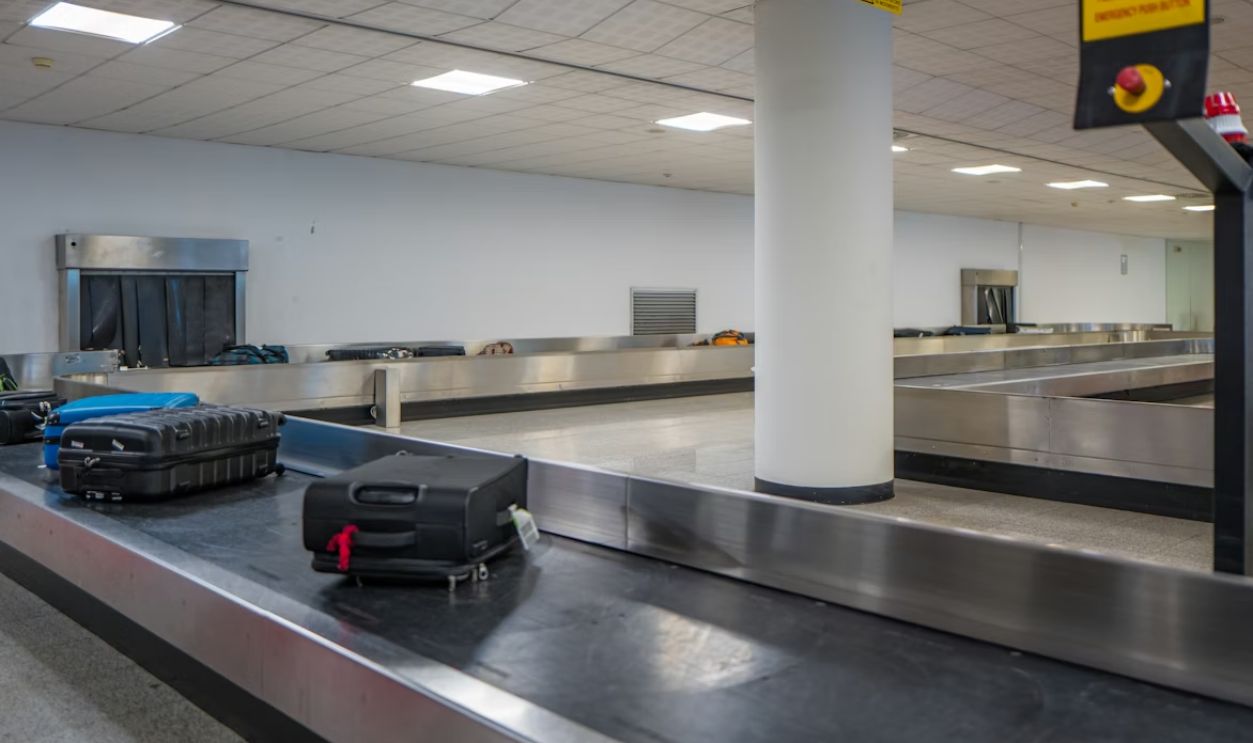 Luggage on a conveyor belt at an airport baggage claim.